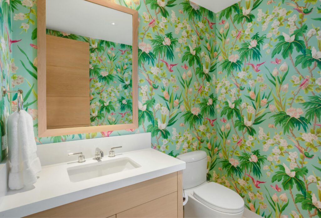 modern bathroom with oak wood and white finishes and a tropical green and pink floral wallpaper