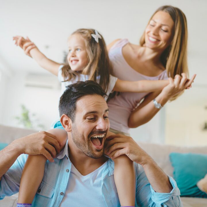 Happy family enjoying a freshly cleaned home after recurring house cleaning in Edmonton.
